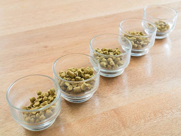 istock Hops pellets in glass cup for brewing beer 586708576