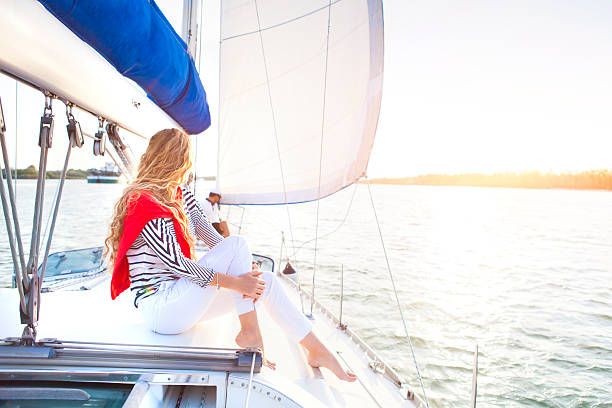 istock Young woman on a sailing boat at summer 586708784