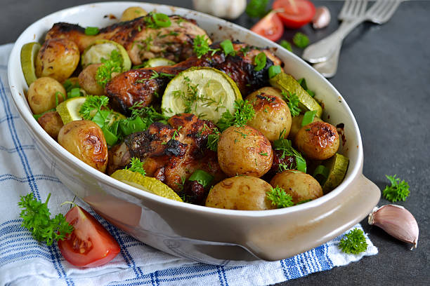 istock Baked potatoes with chicken and vegetables on a black background 586708850