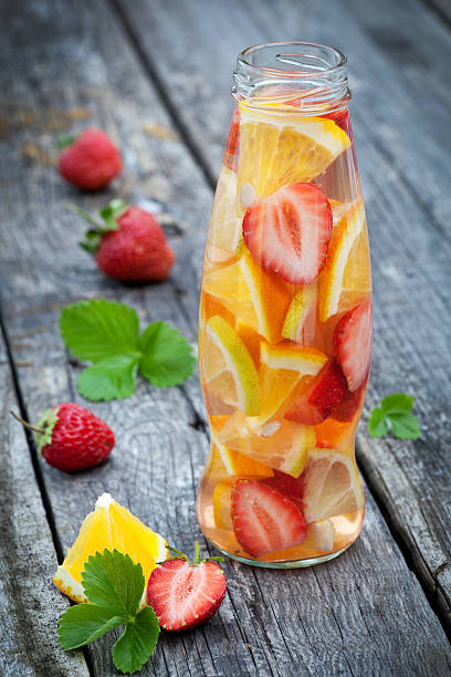 istock Fresh fruit detox water in bottle on wooden table 586709180
