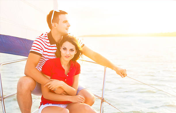 istock Young smiling couple on a sailing boat at summer 586709650