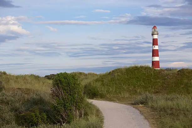 The lighthouse on the Dutch island of Ameland with dune path in the foreground.