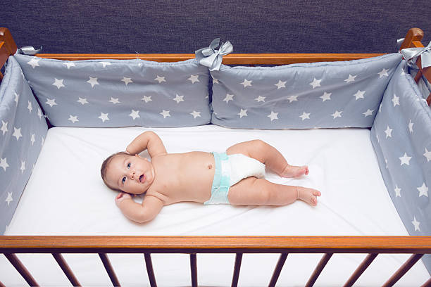 istock Infant baby laying in decorated cot 586712926