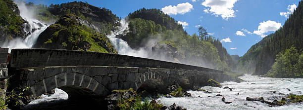 latefossen waterfall with stone bridge in norway - bridge norway odda falling imagens e fotografias de stock