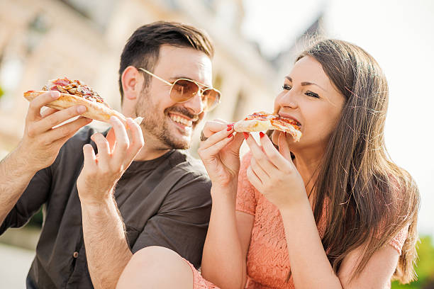 istock Young couple eating pizza 586714264