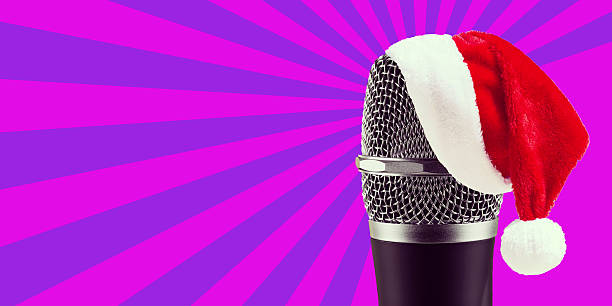 istock Santa Claus Hat on wireless microphone on purple stripes backgro 586715020