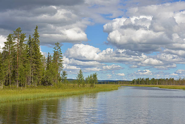 istock Summer landscape. North river and white clouds 586715546