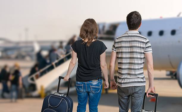 istock Young couple is travelling on vacation. Couple with baggages. 586716926