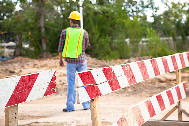 istock Engineer, surveyor surveys the land at construction site. 586718242