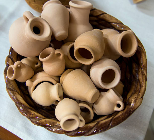 istock Small souvenir clay pots in a wicker basket 586718910