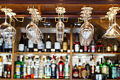 different glasses hanging over the bar. Soft focus.