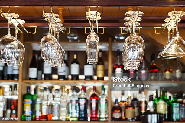 Different Glasses Hanging Over The Bar Soft Focus Stock Photo - Download Image Now