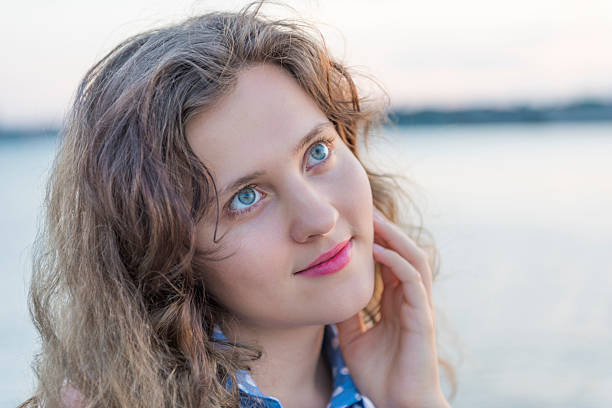 Portrait of a blonde in a landscape outside the window