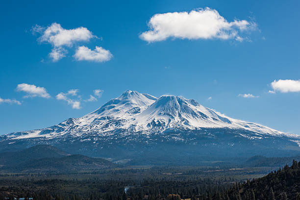 Snowcapped Mount Shasta volcano during winter with valley view