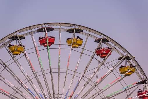 Santa Monica, USA - December 27, 2015: Ferris wheel at Pacific Park with gondolas during sunset