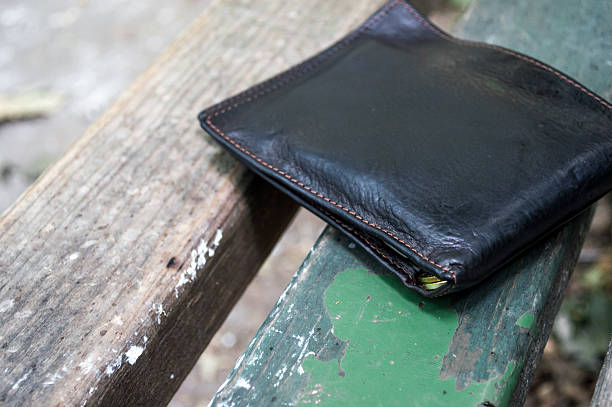 istock Lost Wallet on a Park Bench Close Up 586725620