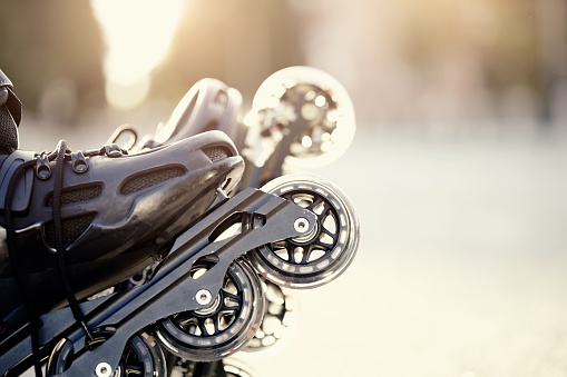 Wheels of roller skates closeup in the rays of the sun.