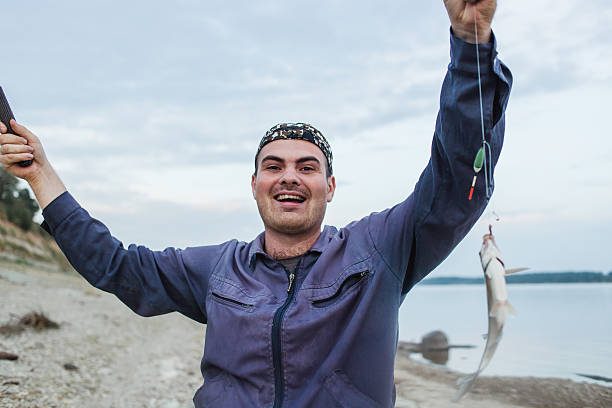 istock The fisherman has hooked fish. Fresh-caught bream 586725824