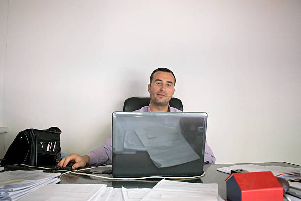 istock Young businessmen looking at data on laptop 586726302