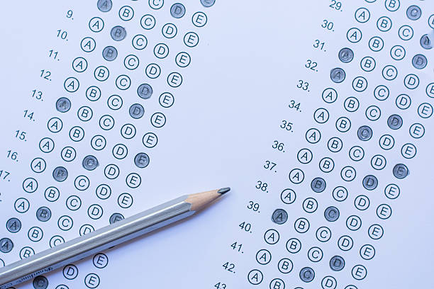 istock Standardized test form with answers bubbled in and a pencil 586726502