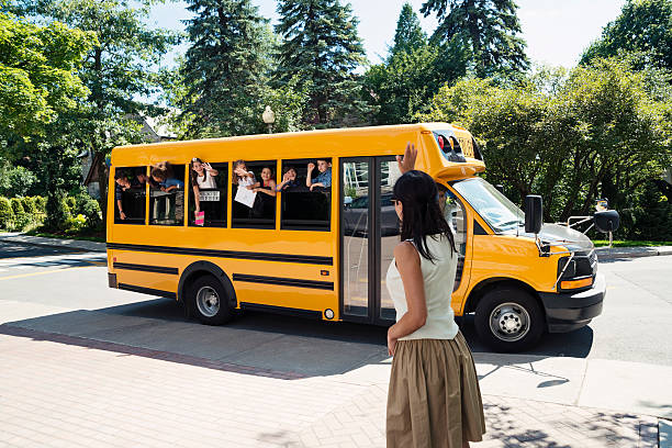istock Group of elementary school kids in yellow school bus. 586727342