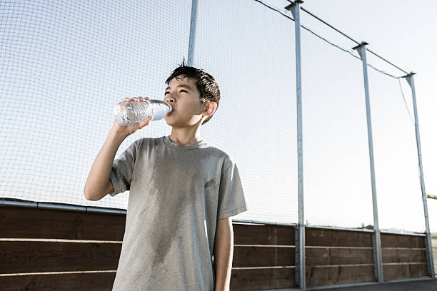 istock Boy drinks water on a hot day. 586728790