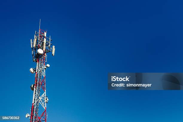 Cell Phone Antenna Tower With Blue Sky Background Stock Photo - Download Image Now - Communications Tower, Telecommunications Equipment, Tower