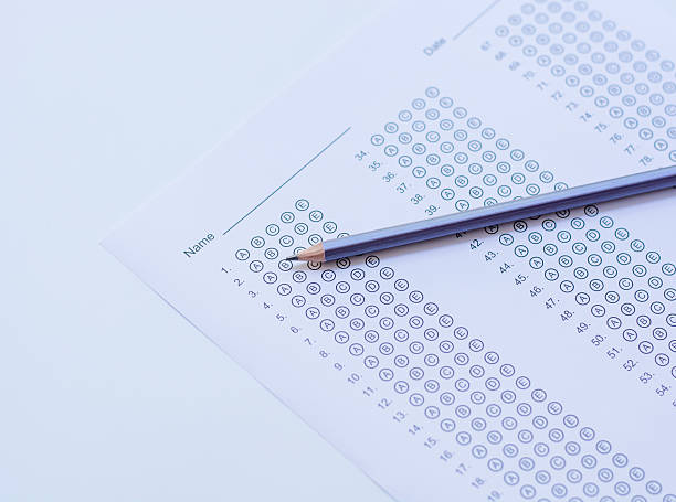 istock Standardized test form with answers bubbled in and a pencil 586730538