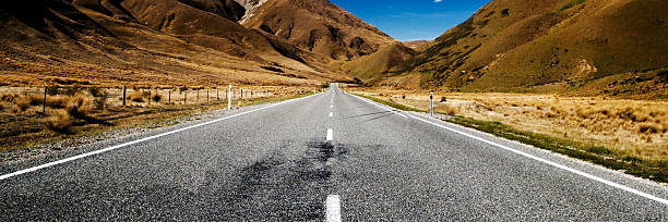 istock Continuous Road in a Scenic with Mountain Ranges Afar Concept 586731522