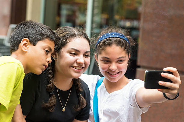 istock Hispanic children taking a selfie 586732322