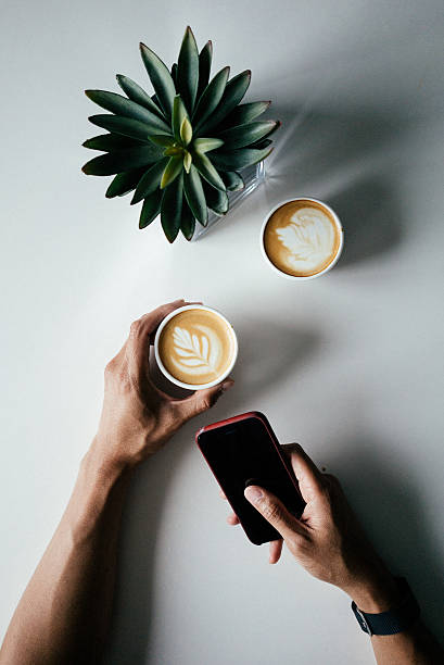 Holding a cup of coffee at a cafe