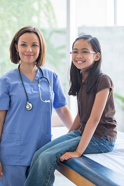 istock An elementary age girl is getting a check up at the 586735830