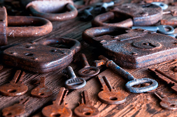 istock Old rusty padlock and keys on wooden background 586749046