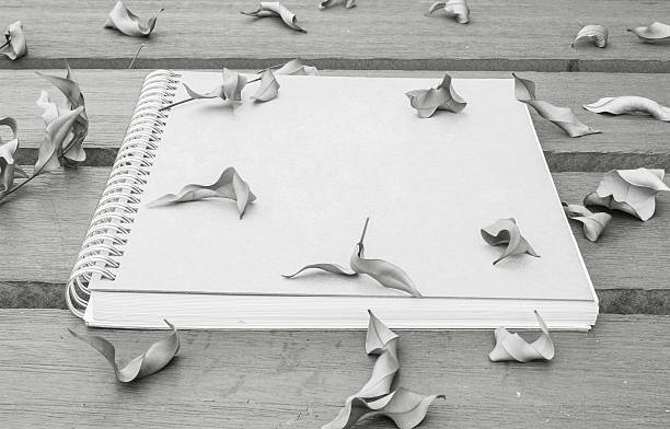 istock Closeup note book on wooden table in the garden 586750752