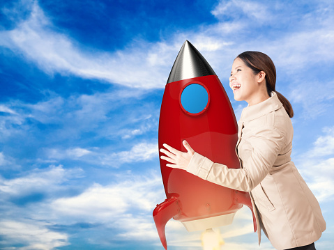 asian businesswoman holding rocket represent to start up concept