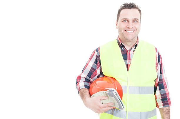 istock Smiling handsome builder holding safety equipment 586923522