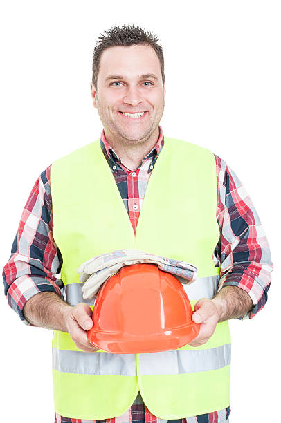 istock Cheerful male constructor holding helmet and gloves 586923564