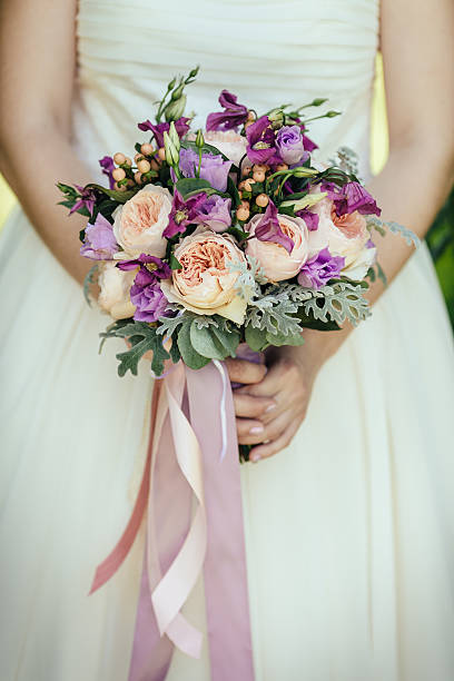 istock Bride holding wedding bouquet 586923798