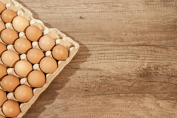 istock Close up eggs in carton package on a wooden table 586923986
