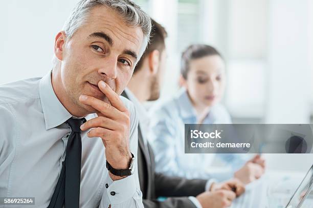 Confident Smiling Businessman Posing Stock Photo - Download Image Now - Adult, Blue-collar Worker, Brainstorming