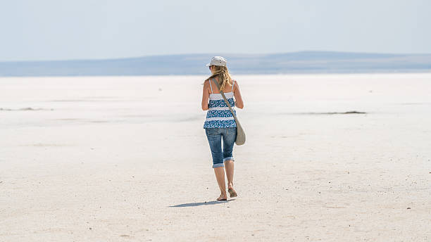 istock woman walking salt lake turkey 586925668