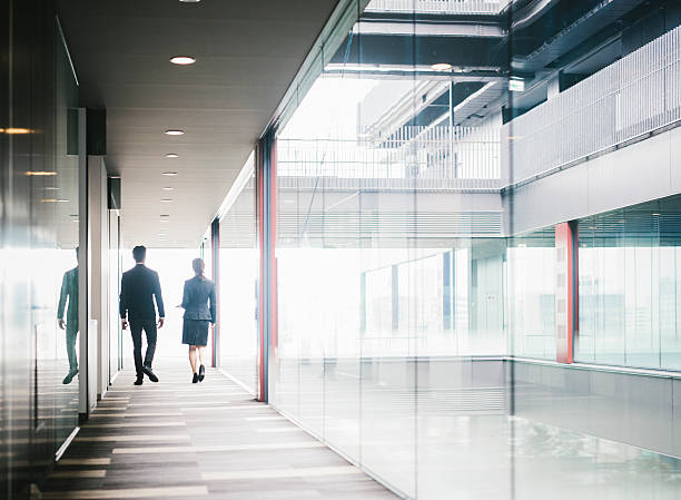 istock Two Entrepreneurs Walking Down the Hallway 586926042
