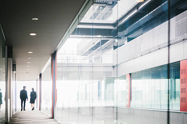 istock Two Entrepreneurs Walking Down the Hallway 586926184