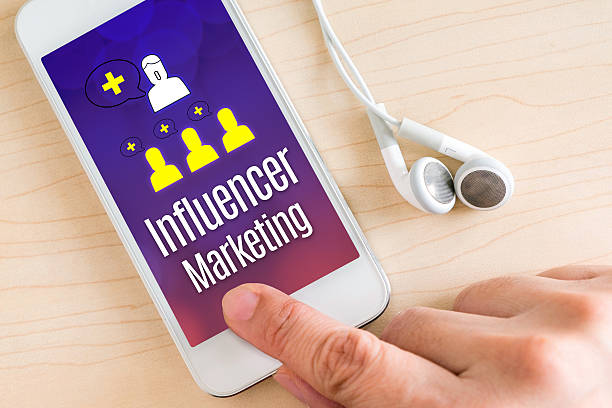 istock Hand touch smart phone with Influencer Marketing 586927244