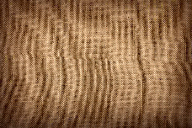 Brown burlap jute canvas background with shade Natural brown burlap jute sackcloth bagging canvas texture pattern background with dark shade border burlap photos stock pictures, royalty-free photos & images