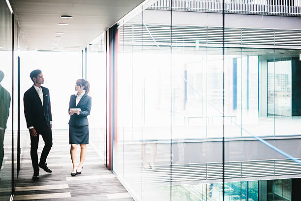istock Two Entrepreneurs Walking Down the Hallway 586927976