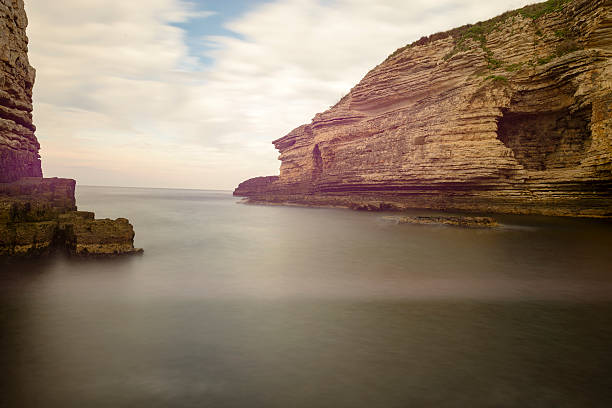 istock beautiful yellow rocks on the sea 586929360