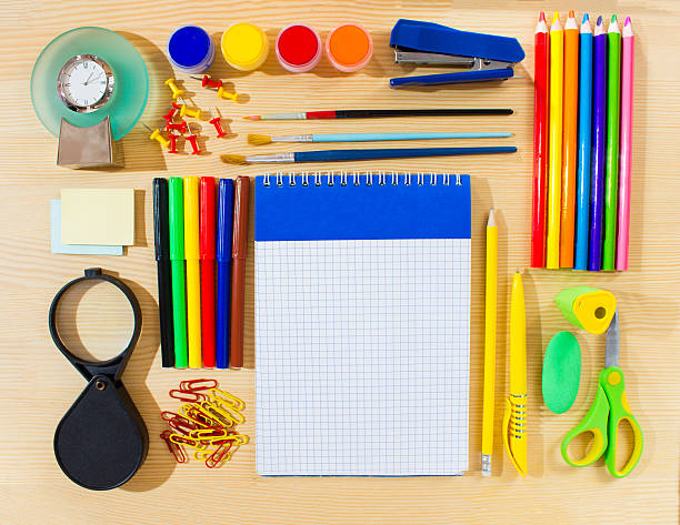 istock School items making frame on wooden background with a space 586931312