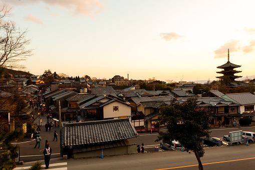 Kyoto, Japan - March 15, 2012: View of the peaceful streets and houses in the Gion district in Kyoto, Japan during sunrise. People can be seen walking around.