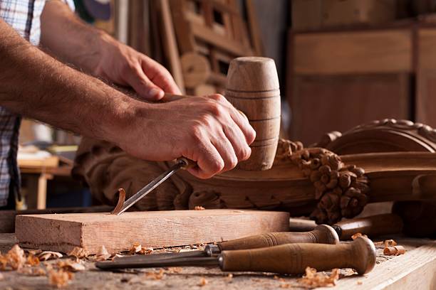 Hands of craftsman carve  with a gouge stock photo